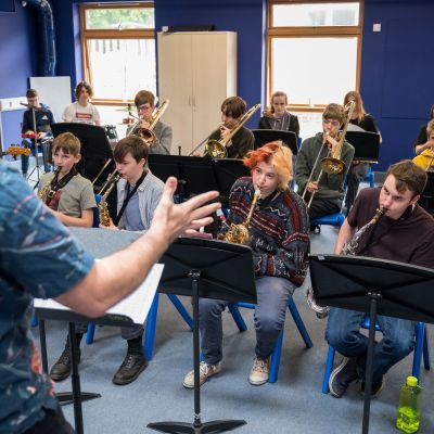 Young musicians playing brass instruments.
